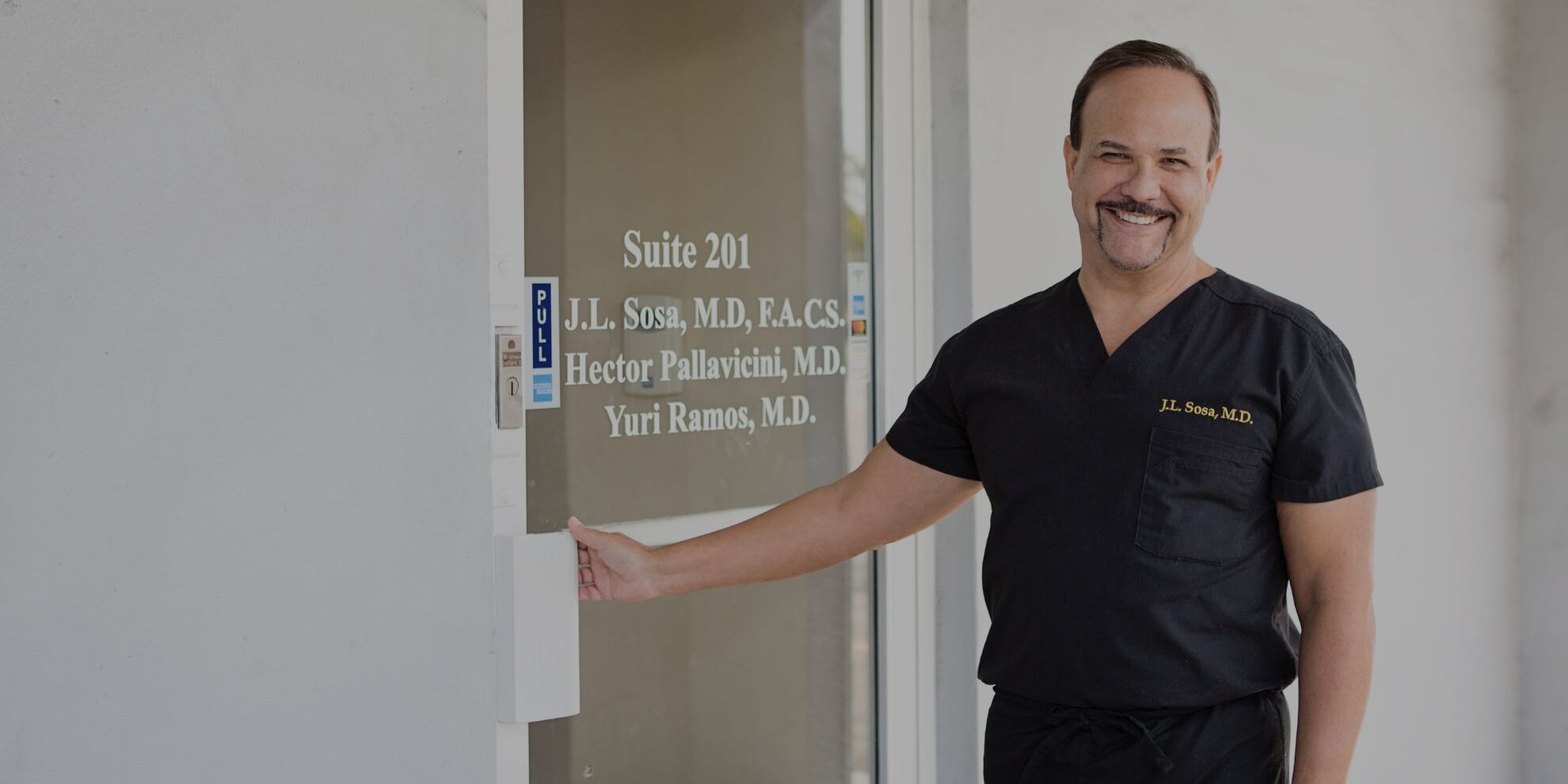 Dr. Sosa opening the door to his clinic