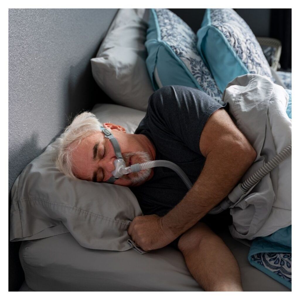 a man using a sleep apnea machine