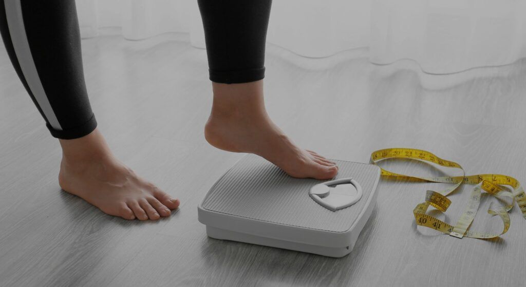 a person stepping onto a scale