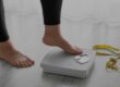 a person stepping onto a scale