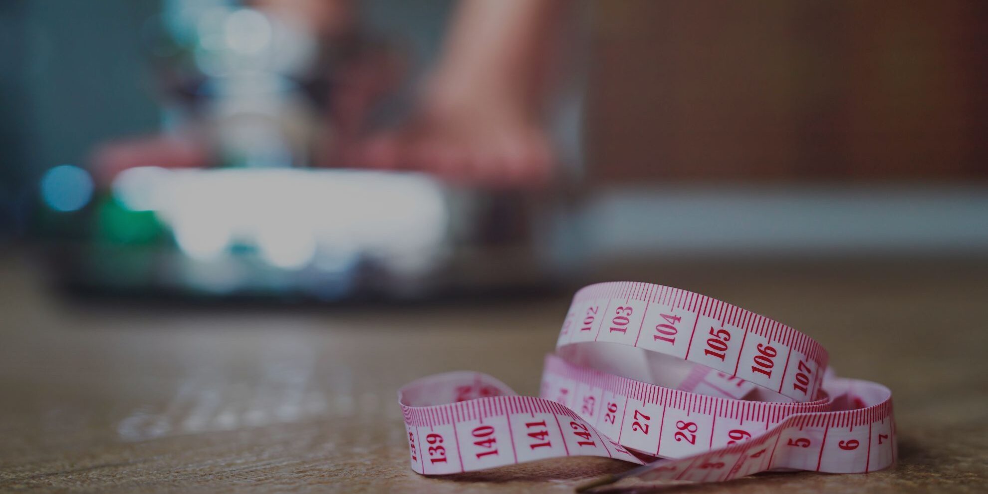 someone weighing themselves with a tape measure in the front