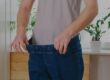 someone stretching their pants after losing weight